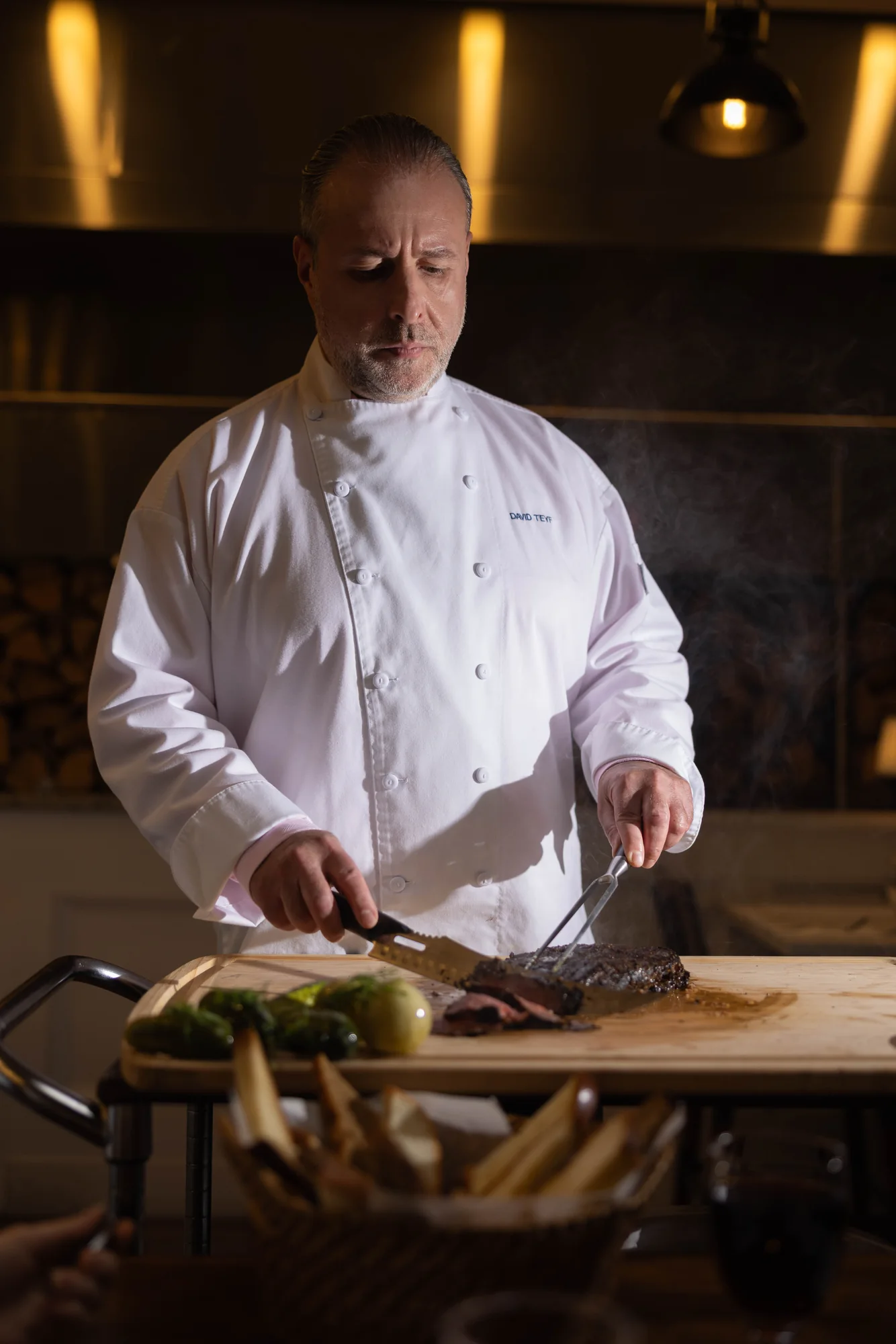 Chef David Teyf carving pastrami at Greenwich & Delancey.