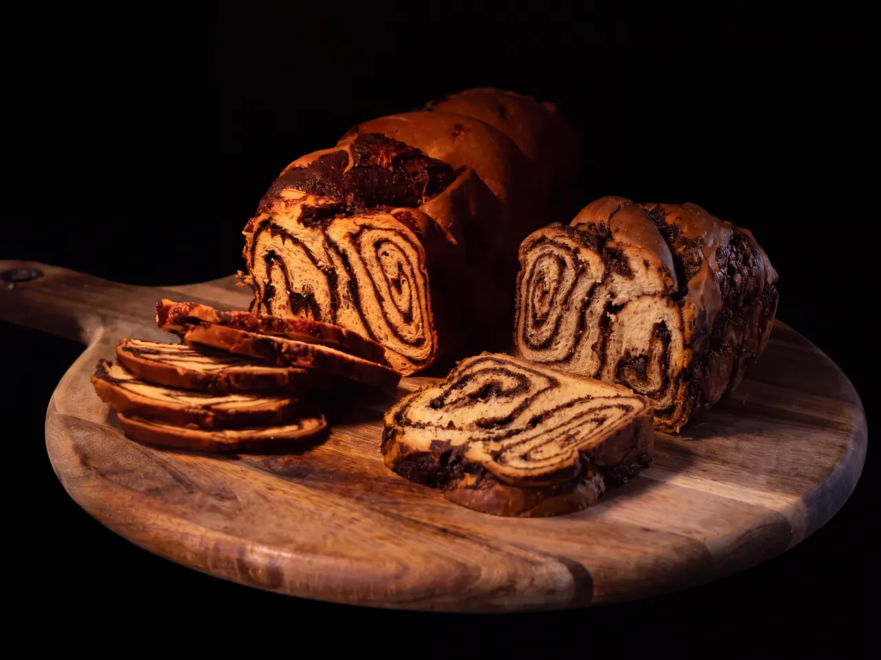 Chocolate babka, sliced on a wooden board
